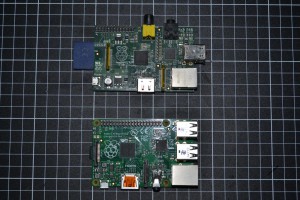 >Raspberry Pi Model B with the model B+ towards the bottom of the picture. The grid is 10mmx10mm